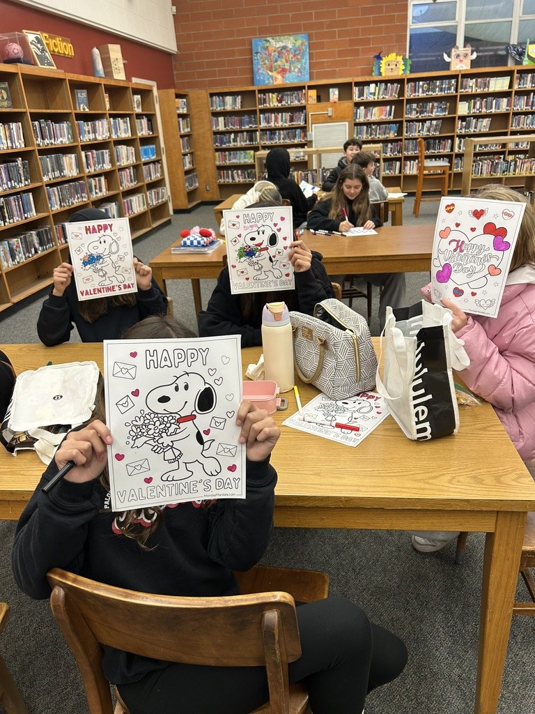 Students sharing their artwork during a workshop.